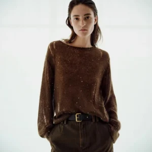 A full-wool knitted sweater with a slightly transparent design and hollowed-out holes for women